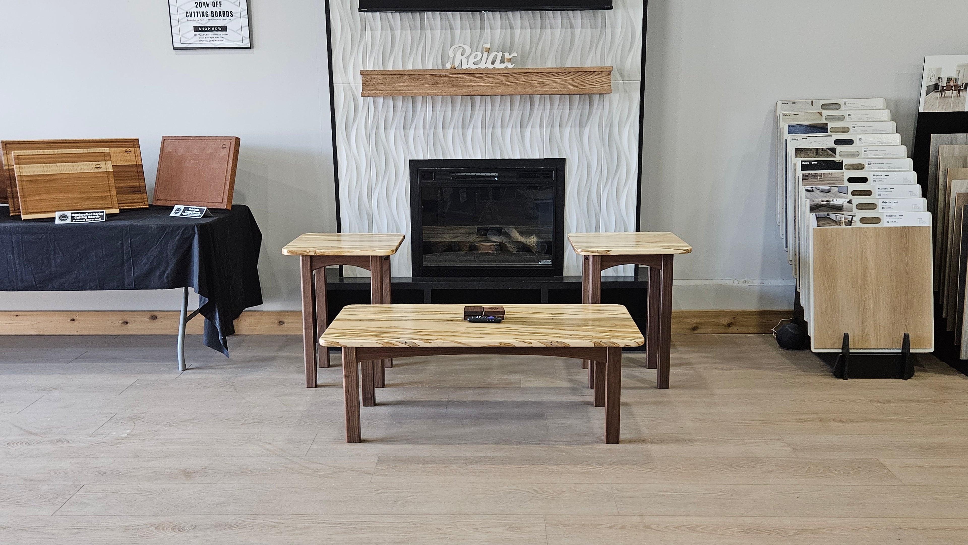 Custom Furniture displayed on showroom floor. Custom Coffee table, walnut base, wormy maple top